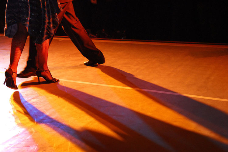Low section of couple dancing on floor