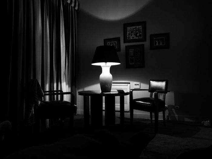 Illuminated lamp on table in room