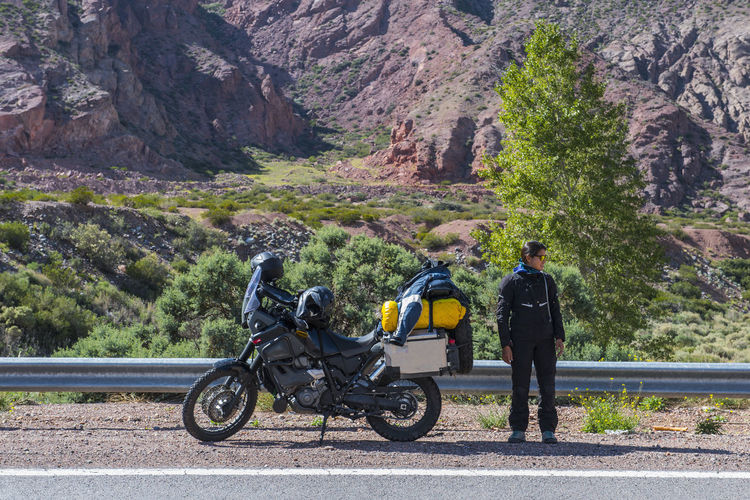 Woman standing next to touring motorbike, mendoza - argentina