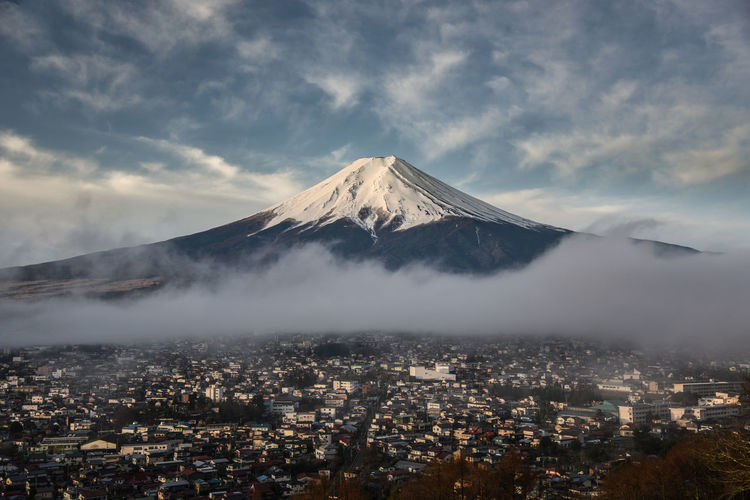 View of mt fuji and cityscape against sky