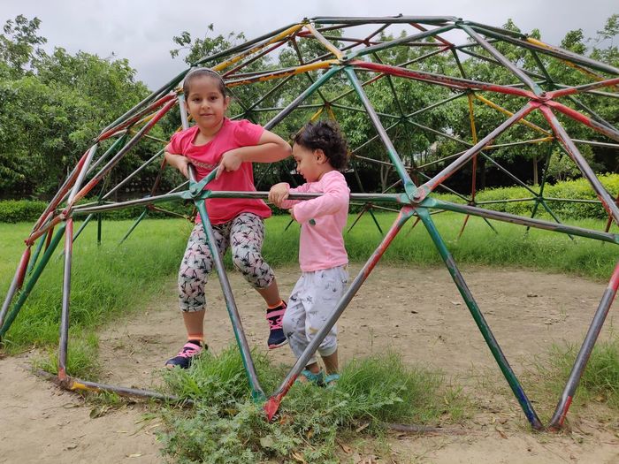 Children playing on jungle gym in playground