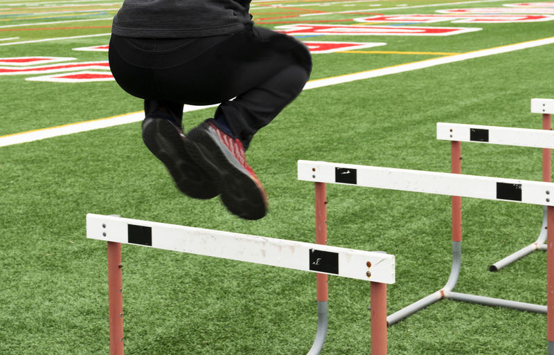 Low section of woman exercising on field