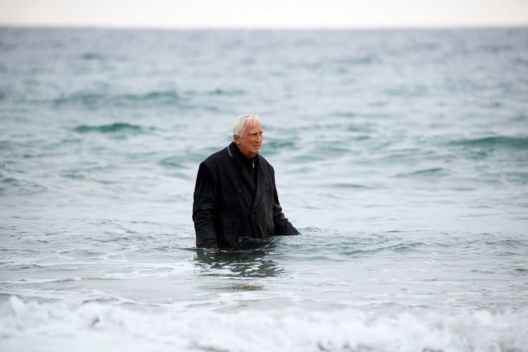 Man wading in sea