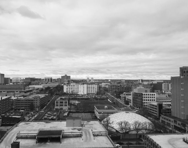 Cityscape against cloudy sky