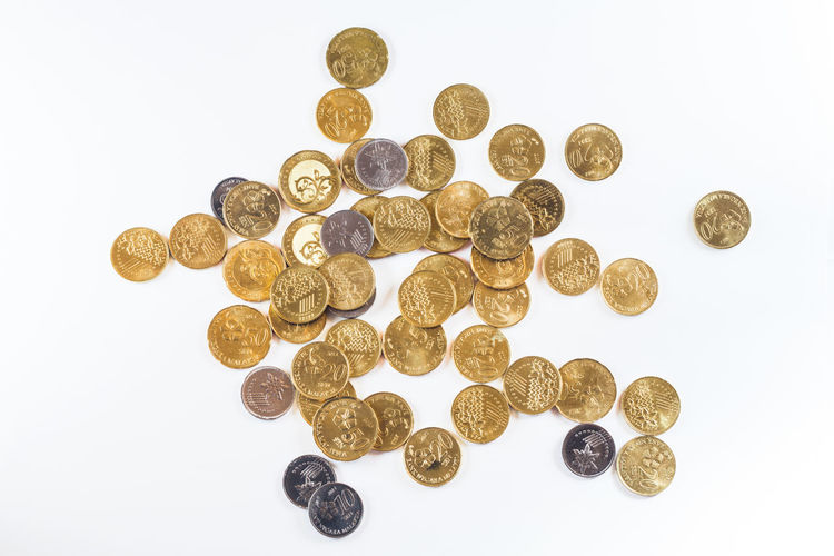 Directly above shot of coins on white background