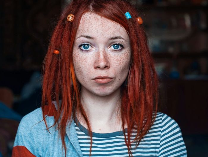 Close-up portrait of woman with redhead