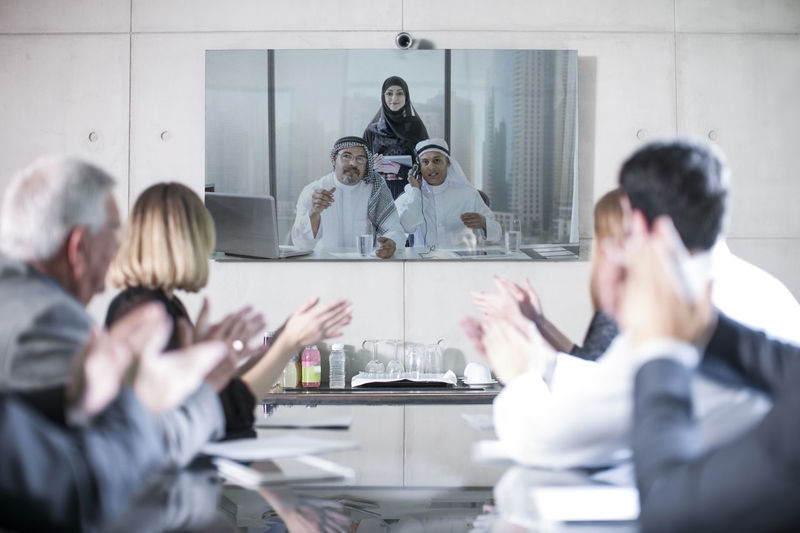 Business people in video conference with clients from the middle east
