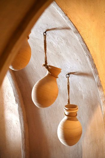 Low angle view of hanging amphorae