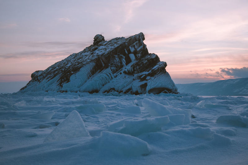 Scenic view of snowcapped mountains against sky during sunset