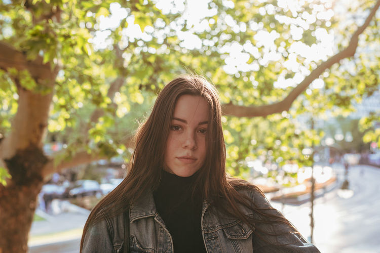 Portrait of young woman in city