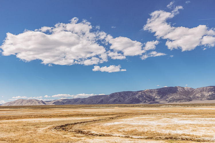 Scenic view of arid landscape against sky