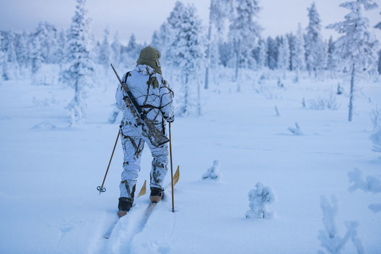 Hunters in winter forest