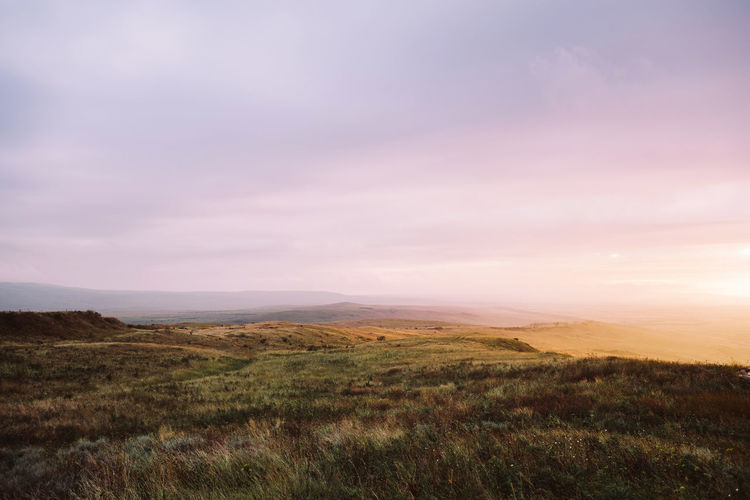 Scenic view of landscape against sky during sunset
