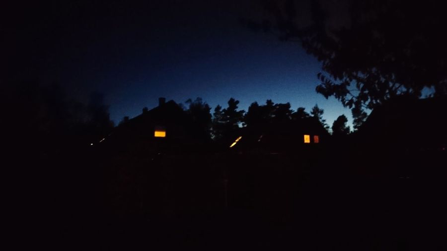 Low angle view of silhouette house against sky at night