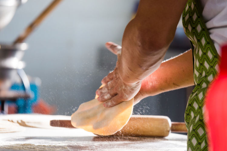 Low section of man making chapatti
