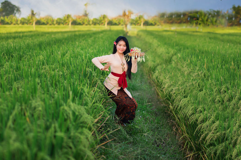 Girl dancing in the middle of paddy field
