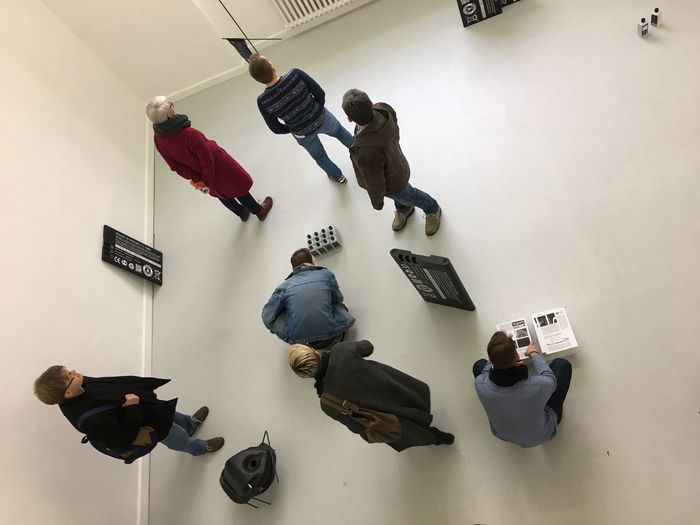 High angle view of men hanging on wall