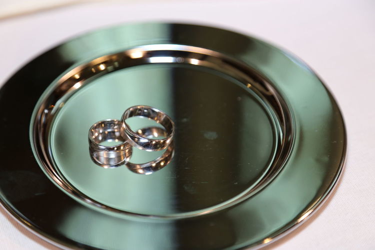 Close-up of wedding rings in plate on table