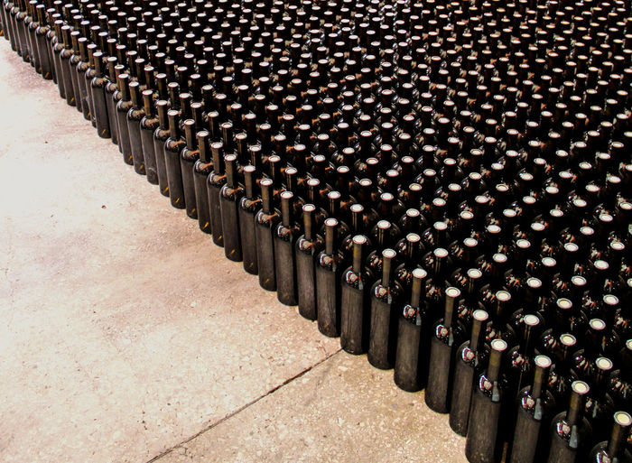 High angle view of wine bottles arranged in cellar
