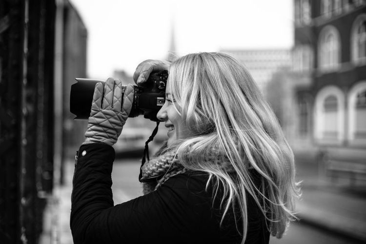 Side view of a blonde female photographer. 