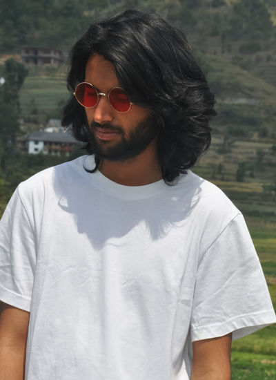 Portrait of mature man wearing sunglasses standing outdoors