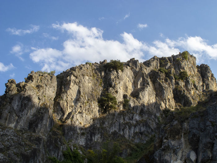 Low angle view of rock formations against sky
