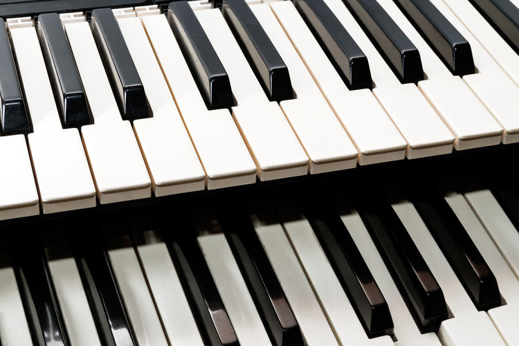 Parts of two classical music keyboard close up