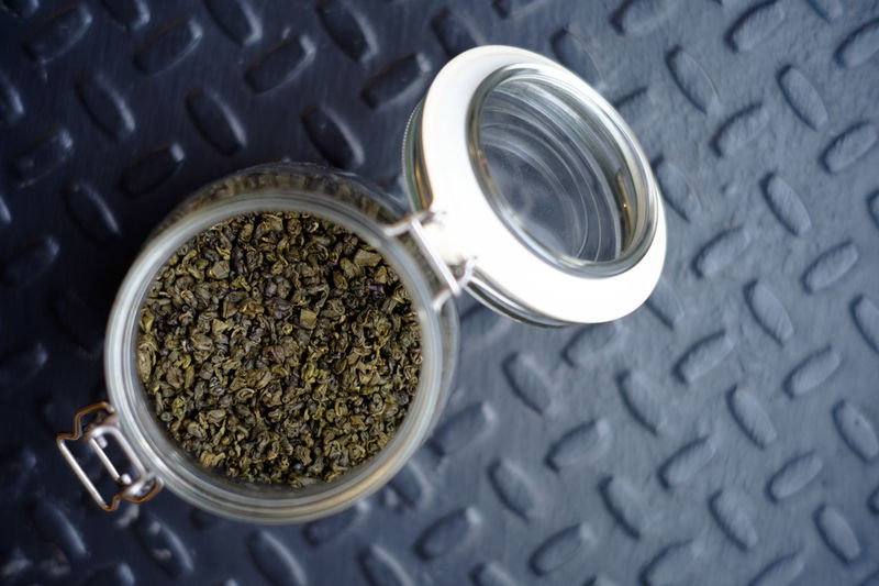 High angle view of coffee beans in jar on table