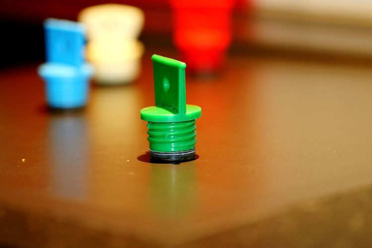 Close-up of multi colored bed bottle closure on table