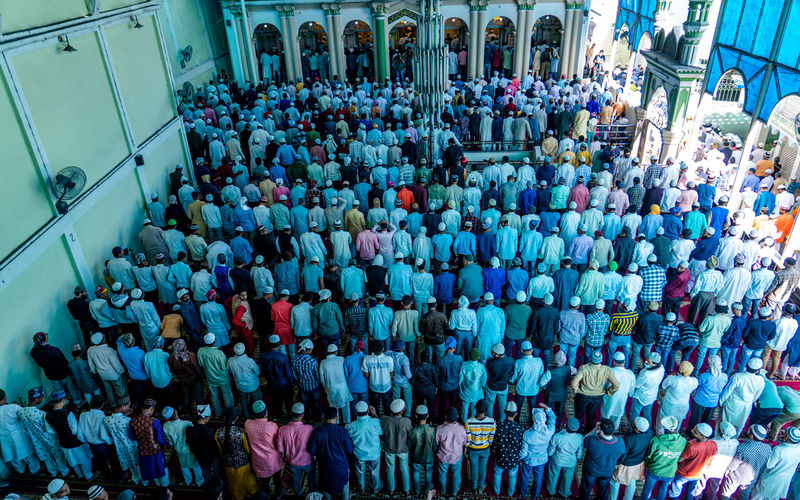 High angle view of people praying in mosque