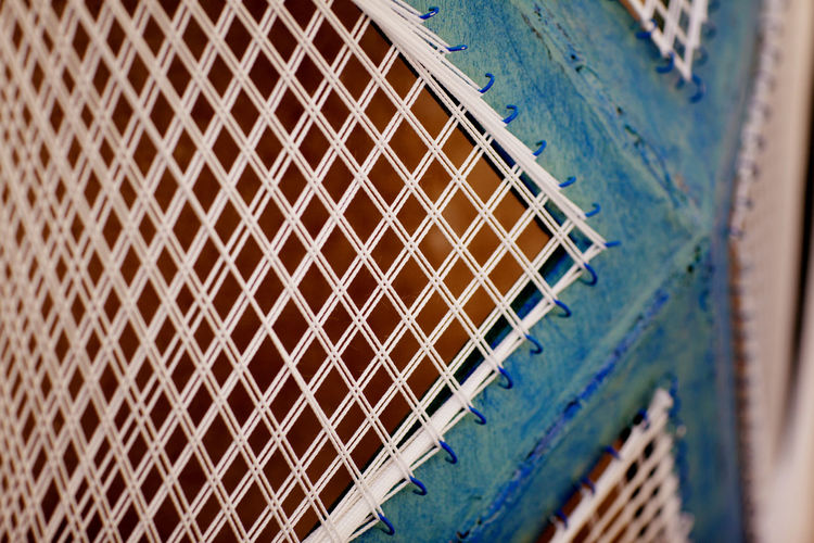 Close-up of metal fence against wall