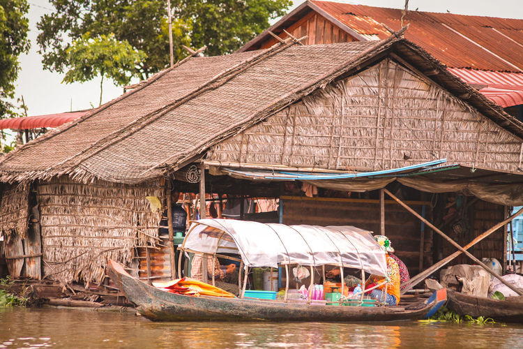 Boathouse beside stilted house in tonle sap