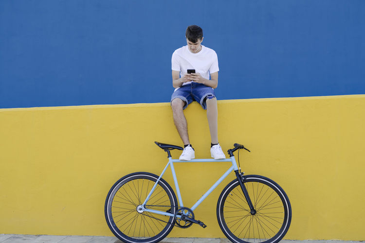 Cyclist with leg prosthesis using mobile phone