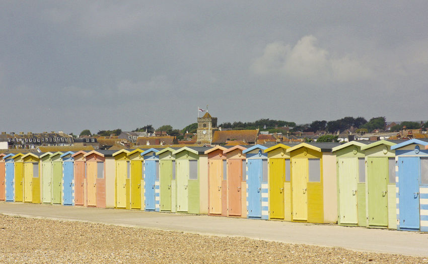 Beach huts against sky in city