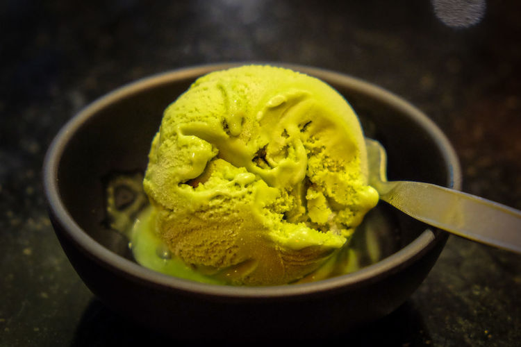 Close-up of yellow ice cream served on table