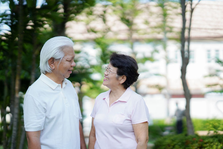 Rear view of man and woman walking outdoors