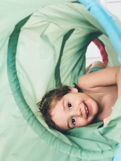 Portrait of cute boy lying on bed