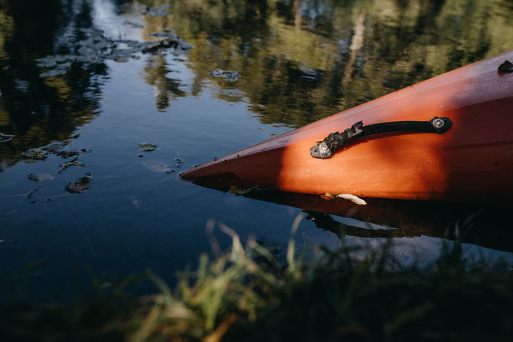 Red kayak on riverside
