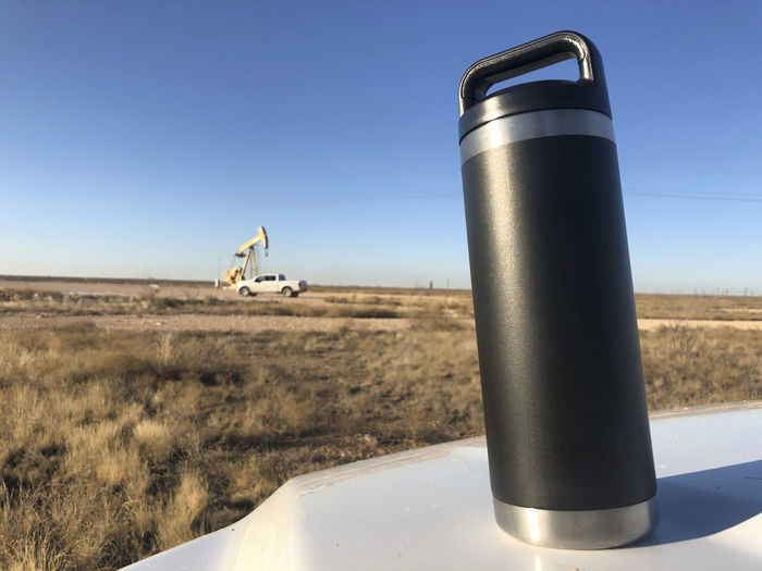 Coffee thermos on truck hood with pump jack