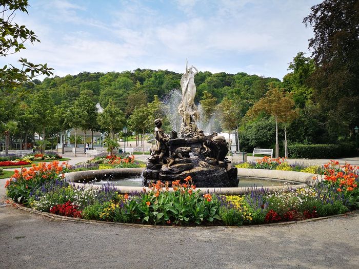 View of fountain in park against sky