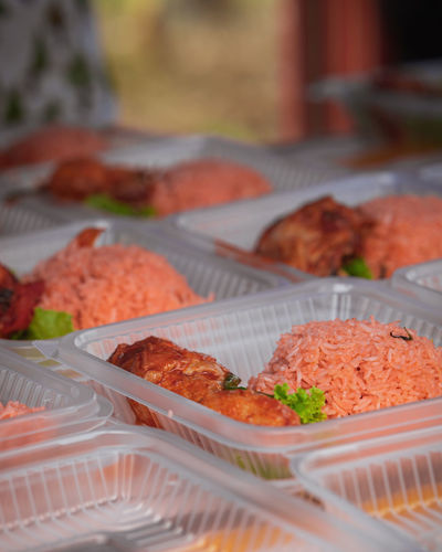 Nasi ayam tomato in takeaway container for sale in a stall in malaysia.