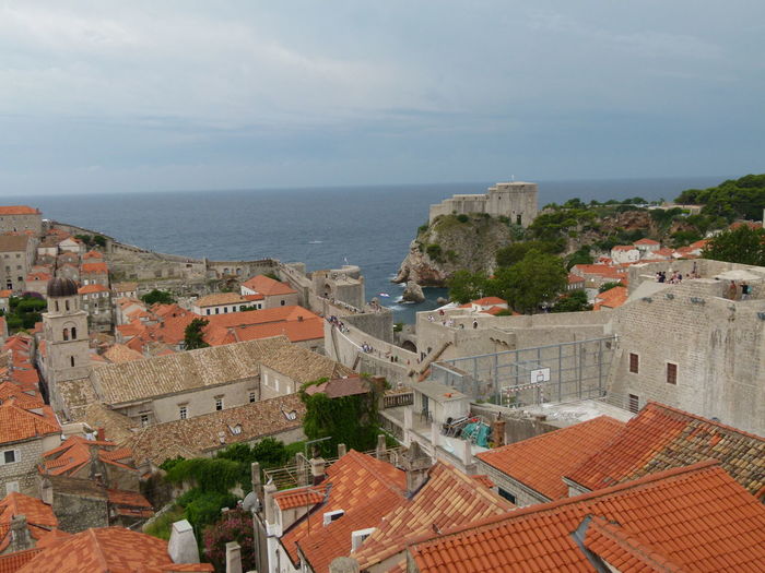 High angle view of buildings by sea against sky in old town
