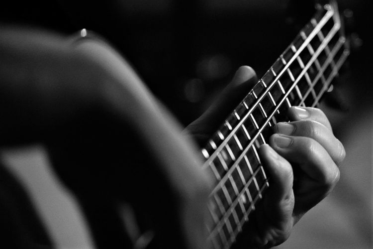 Close-up of man playing guitar