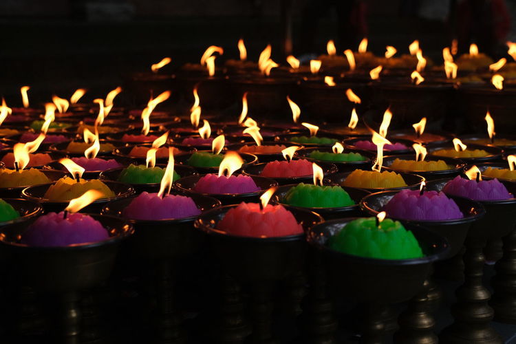 Close-up of multi colored candles on temple