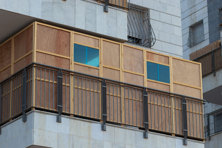 A wooden sukkah inside the balcony of a building, the jewish holiday of sukkot