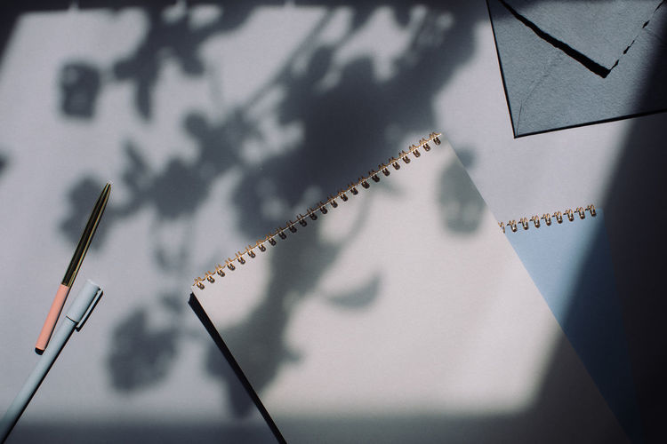 High angle view of notebook and pen on table