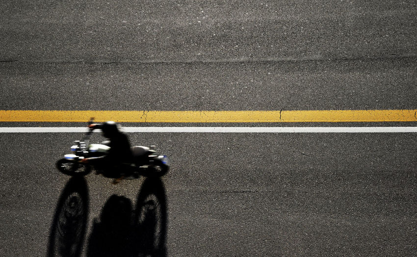 High angle view of person riding motorcycle on road