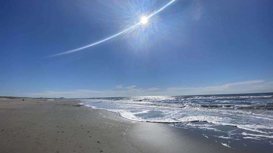 Scenic view of sea against sky on sunny day