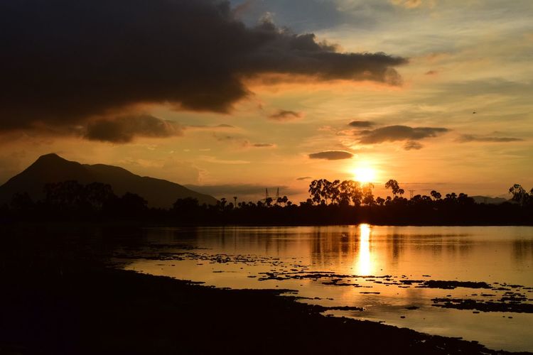 Scenic view of lake against sky during sunset