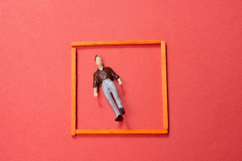 High angle view of toy against red background